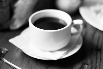 A cup of coffee tea in a cafe black and white photo