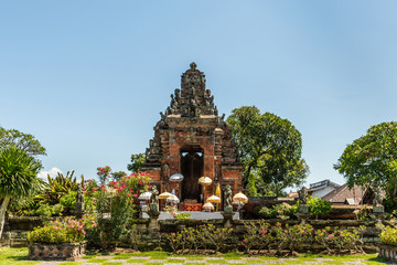 Klungkung, Bali, Indonesia - February 26, 2019: Red brick and gray stone ornaments of door and...