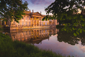 Fototapeta na wymiar Royal Palace on the Water in Lazienki Park, during the sunset, Warsaw, Palace on the water in the Royal Baths in Warsaw, Poland 