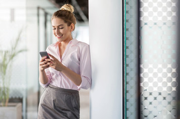 Business woman using smartphone in office
