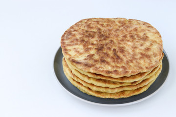 Homemade tortillas, located on a plate on a white background