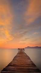 Wooden pier / jetty, playa de muro, Alcudia, sunrise, mountains, secluded beach, golden sunlight, reflection, beautiful sky, clouds,landmark, mallorca, spain.