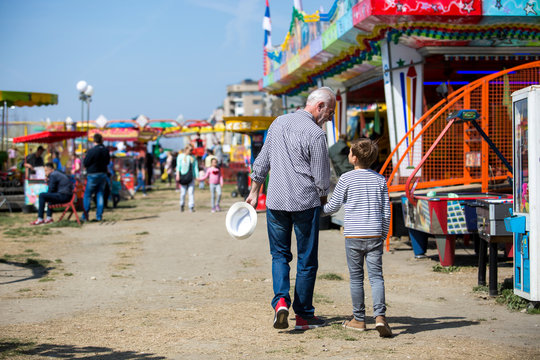 Grandfather and grandson amusement park fun - Powered by Adobe