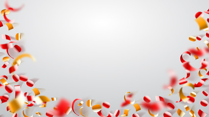 Abstract background of flying shiny confetti and pieces of serpentine, golden and red on white