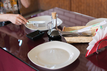 served table in a cafe with empty plates. Preparing for lunch, waiting for food.