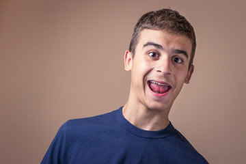 Obraz premium Young man smiling. Human facial expression, emotion, body language funny