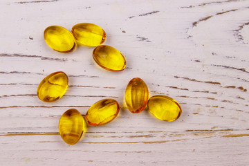 Omega 3 pills on a white wooden table