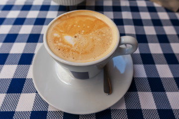 a cup of creamy coffee