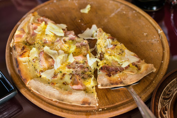 Freshly made pizza on the table. Preparing to eat.