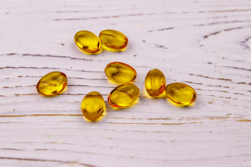Omega 3 pills on a white wooden table