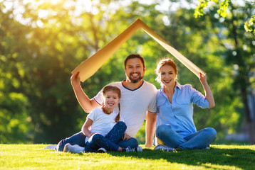 concept of mortgage and housing for   families. mother father and child from   roof of   house on  ...