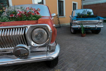 Vintage cars. Car in the square. The flowers in the car.
