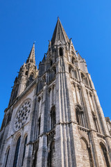 Fototapeta premium Architectural fragments of Roman Catholic Chartres Cathedral or Cathedral of Our Lady of Chartres (Cathedrale Notre Dame de Chartres, 1220). Chartres (80 km southwest of Paris), Eure-et-Loir, France