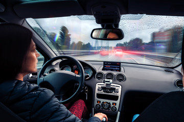 Fototapeta na wymiar Woman driving car on a busy motorway