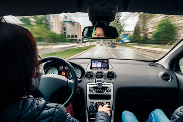 Woman driving car on the city streets