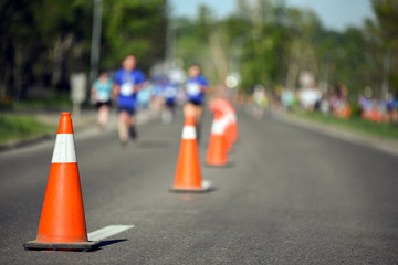 Pylon cones during a marathon with runners in background