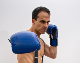 shirtless man with suspenders, boxing glove making fight poses (photo 2/4)