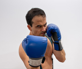 shirtless man with suspenders, boxing glove making fight poses (photo 4/4)