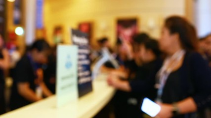 Many business people attending the seminar are scanning QR Code for registration with smart phone and tablat. Blurry Video for background. - Powered by Adobe