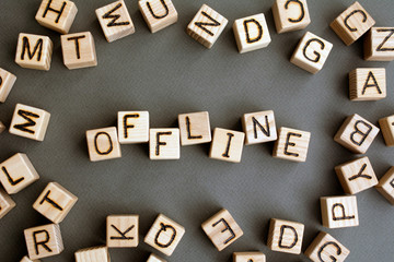 the word offline  wooden cubes with burnt letters, distracting people from social networks,  gray background top view, scattered cubes around random letters