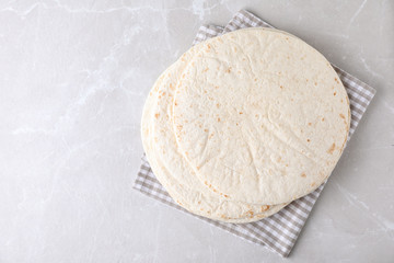 Corn tortillas on light background, top view with space for text. Unleavened bread