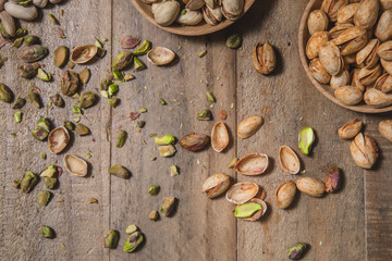 Upclose Pistachio Nuts and Shells Scattered on Wooden Table