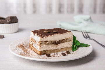 Tiramisu cake with coffee beans on table