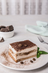 Tiramisu cake with coffee beans on table