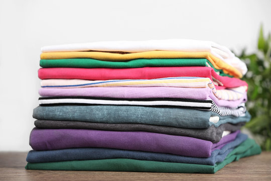 Pile of ironed clothes on table, closeup