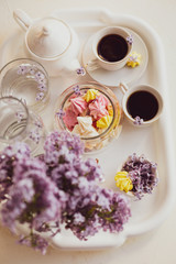 Fototapeta na wymiar Purple spring lilac flowers breakfast still life