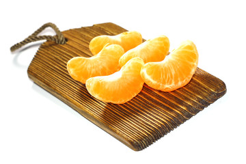 a piece of orange on a dark wooden board  tray isolated on a white background