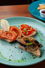 Vegetarian bruschetta with grilled eggplant, tomatoes and bell pepper