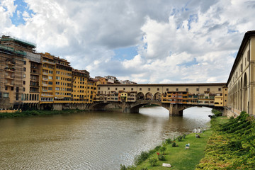View of medieval stone bridge Ponte Vecchio and the Arno River from the Ponte Santa Trinita (Holy Trinity Bridge) in Florence, Tuscany, Italy. Florence is a popular tourist destination of Europe.