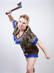 strong woman with short hair and plus size figure in primitive hunter costume with axe aggressively emotionally posing on white background in Studio