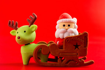 cute santa claus and sled and reindeer on a red background
