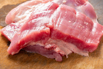 side view raw pork on chop board
