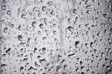 Close Up of Raindrops on Window on a Gray Rainy Day