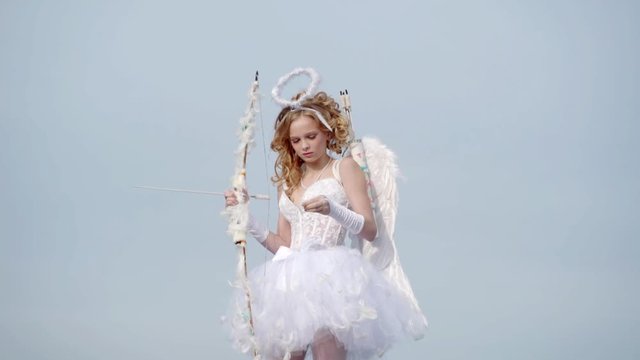 St Valentines day. Angel children girl with white wings. Sweet angel girl. Little angel girl against sunny sky. Teen angel. Lovely and cute youth. Cupid cute girl with a bow