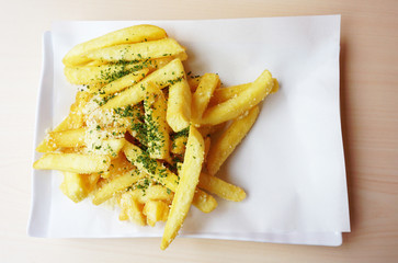 French Fries topped chocolate and mayonnaise in a white dish  on white background, Close up..