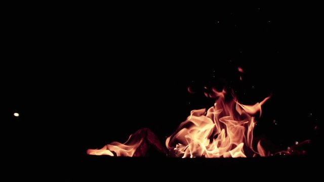 Medium CU of slow motion camp fire