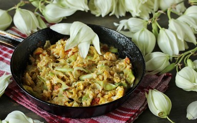 Yucca flowers dish. flower petals fried with eggs and tomatoes. national cuisine of Costa Rica. edible flowers recipe. Yucca is the national flower of Costa Rica