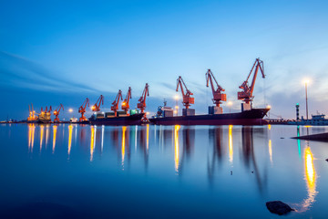 Gantry crane and cargo ship in the evening