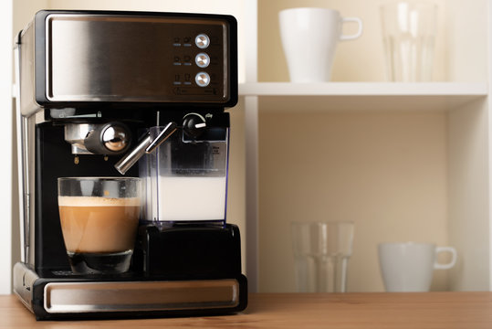 Hot cappuccino, lat in a cup. Prepare a refreshing, invigorating coffee in a glass transparent cup. with space