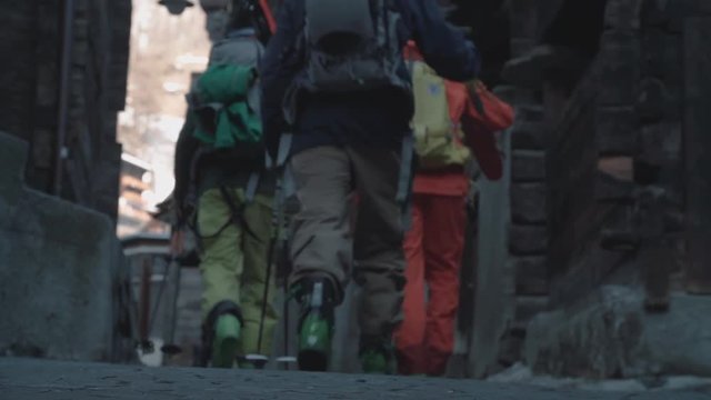 Skiers walk through a small ski town together