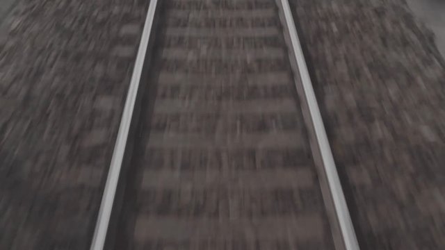Railroad tracks fly by the camera