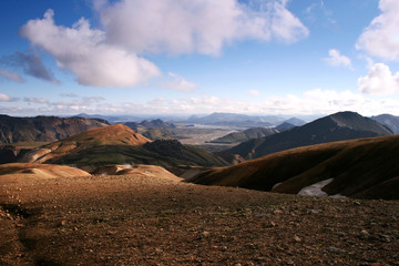 Orange and green mountain range on a sunny day in Landmannalaugar National Park, Iceland.