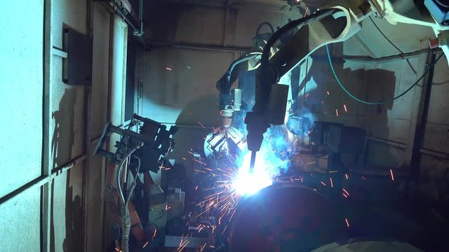 Team industrial robot are movement welding automotive part in factory