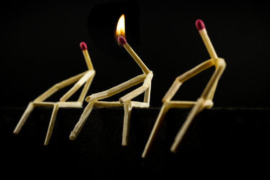 Having an idea and standing out on the team. Conceptual image of creativity, man made of match with flame on head.