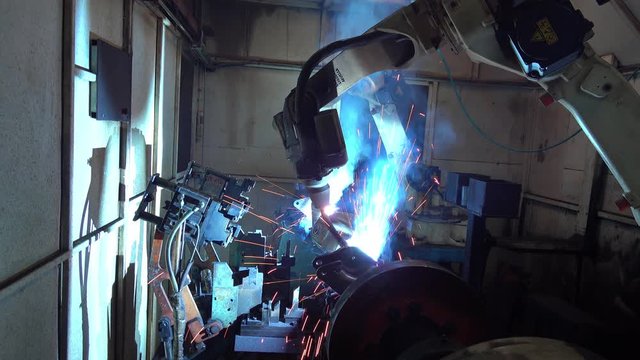 Automation welding mechanical procedure.,Industrial Robot arm active in factory