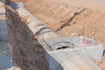 Concrete Drainage Pipe on a Construction Site, Concrete drainage tank on construction site,...